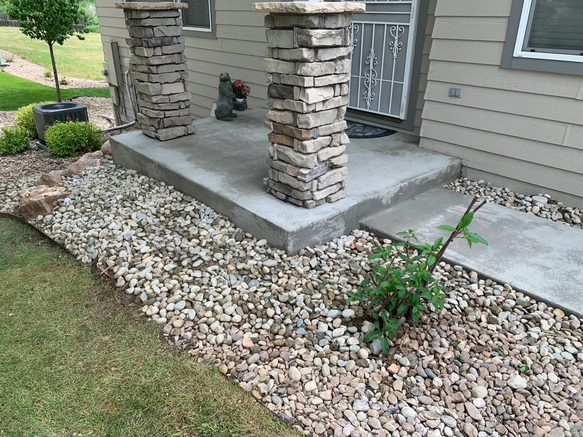 A stone walkway with steps leading to the front door.