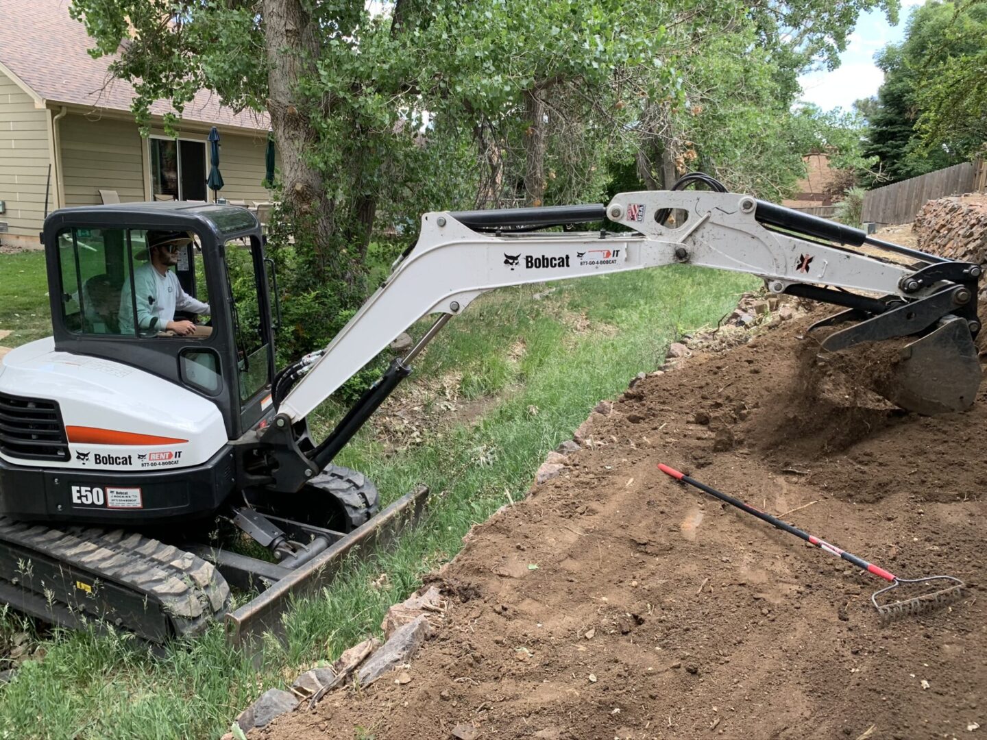 A white and black tractor is on the side of a road