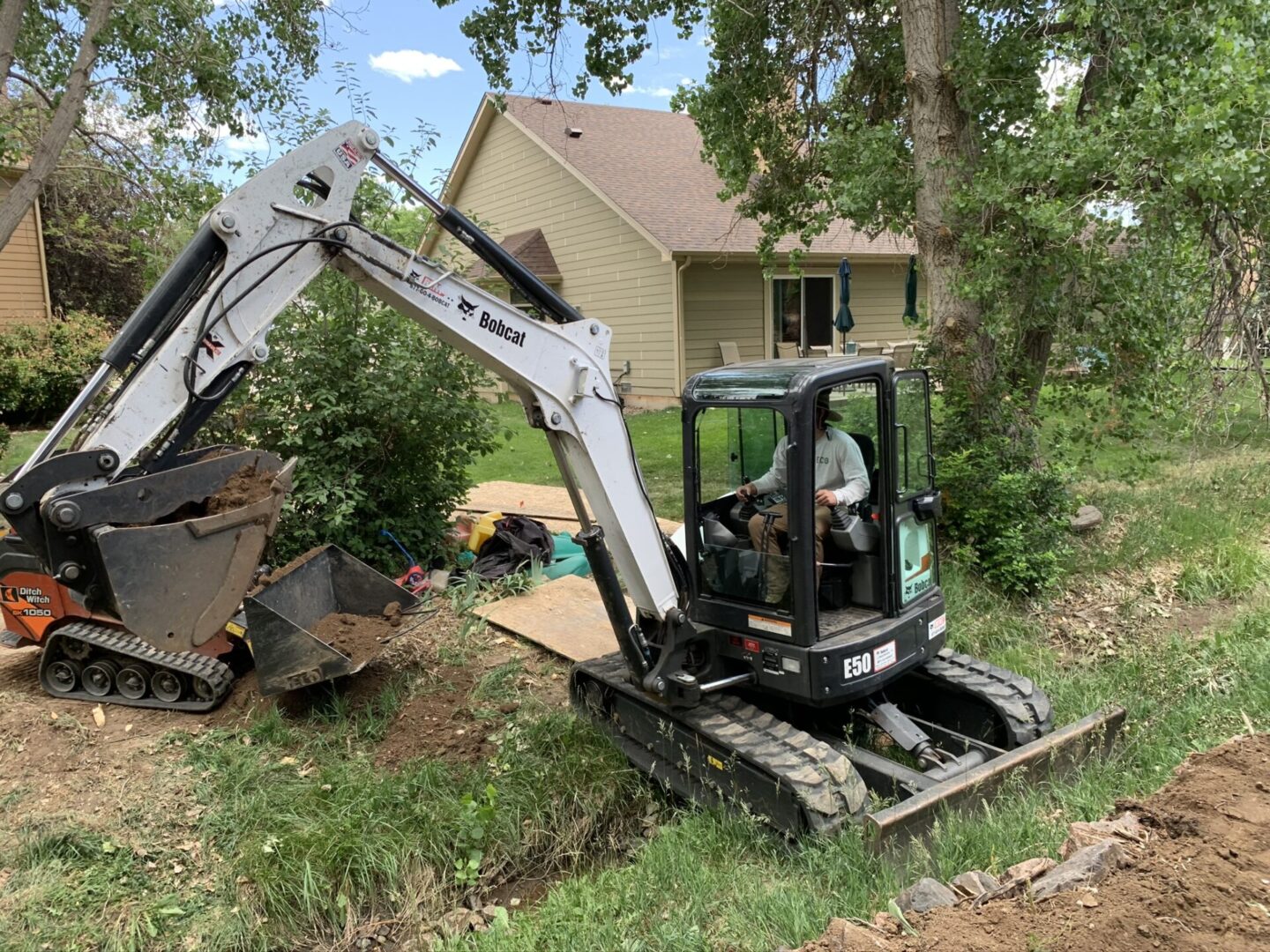 A man in the back of an excavator.